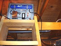 Electrical box with cables and wooden beams.