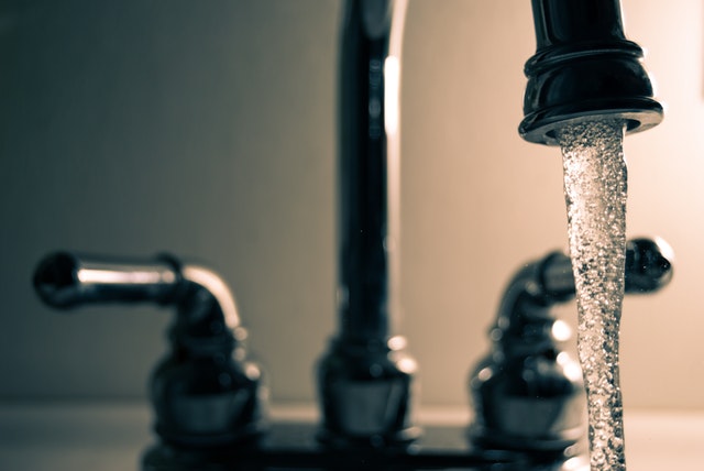 A faucet with water running out of it.